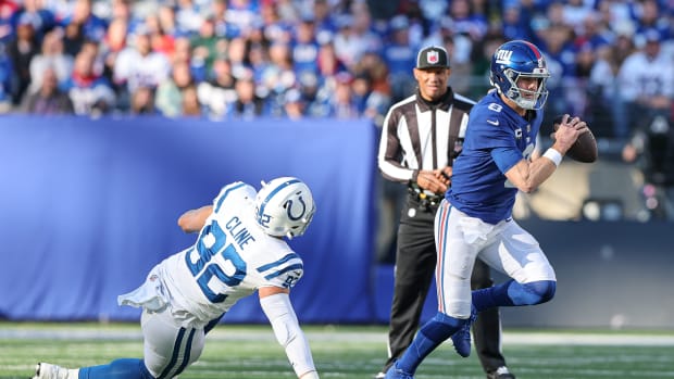 Jan 1, 2023; East Rutherford, New Jersey, USA; New York Giants quarterback Daniel Jones (8) scrambles as Indianapolis Colts defensive end Kameron Cline (92) pursues during the first half at MetLife Stadium.
